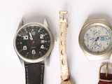 two watches and a watch on a white surface