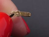 a person holding a red heart shaped object in their hand