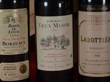several bottles of wine are lined up on a table