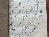 an old book with writing on it sitting on a wooden table
