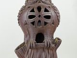 a lamp that is shaped like a tree stump with a face on it