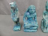 three statues of a man and a woman sitting on top of each other