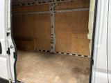 a white van with the door open in a garage