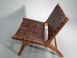 the chair is made of wood and has a brown leather seat