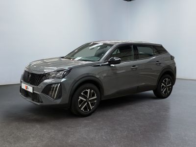 un SUV gris garé dans une pièce aux murs blancs