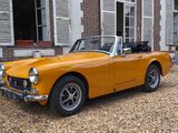 a yellow convertible car parked in front of a building