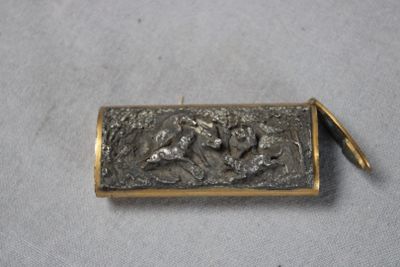 an image of a small metal box with a horse on it