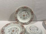 three plates and a bowl sitting on a table