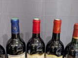 several bottles of wine are lined up in a row on a table
