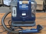 a vacuum that is sitting on a wooden table