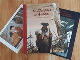 two books that are sitting on a wooden table