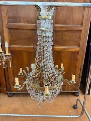 a glass chandelier hanging from a metal frame