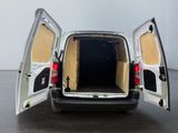 a white van with its doors open in a parking lot