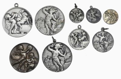 several silver medals of various sizes and shapes on a white background