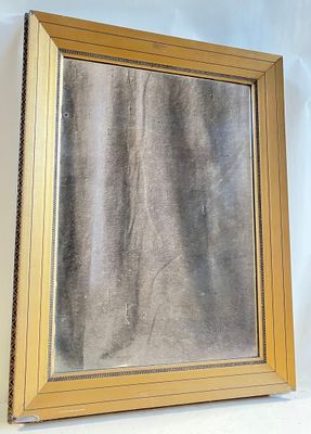 a picture of a gold framed mirror on a white wall