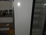 a refrigerator in a room with a lot of items on the shelves