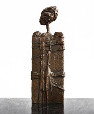 statue of a woman holding a baby in her arms on a table