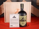 a bottle of liquor sitting next to a wooden box
