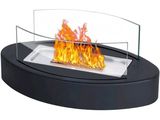 a close up of a fire in a glass bowl on top of a table