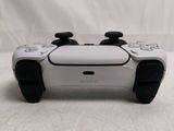 a close up of a video game controller on a white surface