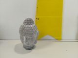 a buddha statue next to a ruler on a table