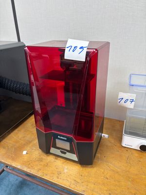 a red and black 3d printer sitting on a table