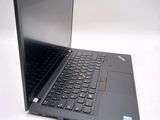 a black laptop with a red button on the keyboard