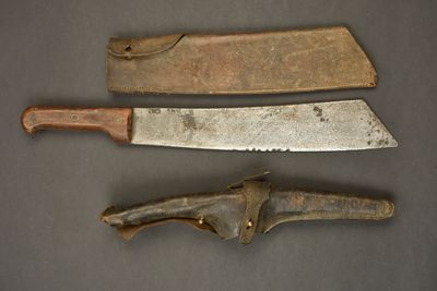 two old knives are sitting next to each other on a table