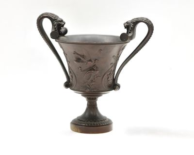 a silver cup that is sitting on top of a table
