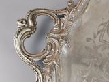 an antique silver plate with ornate design on it on a table