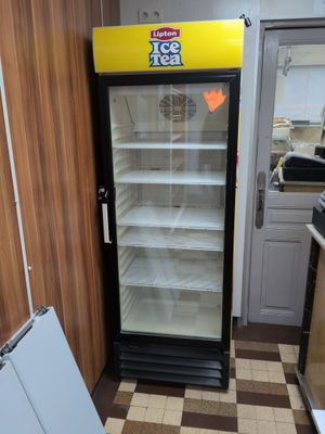 a refrigerator that is sitting in the corner of a kitchen
