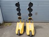 two yellow scooters that are next to a garage door