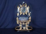 un dôme de verre avec une horloge à l'intérieur sur une table