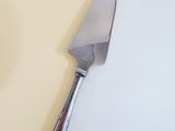 a knife that is laying on a white surface