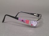 purple and white patterned glasses on a gray surface