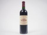 the bottle of wine is sitting on a white surface