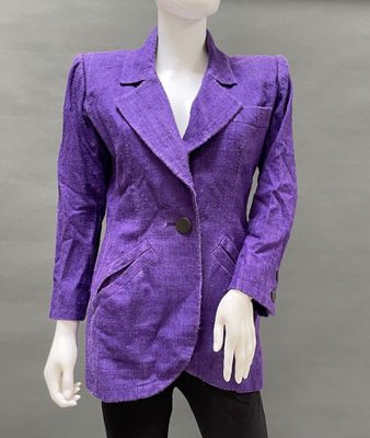 a mannequin wearing a purple blazer and black leggings