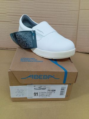 white leather slip - on shoes with a blue stripe on the side