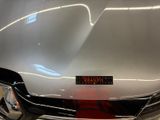 a close up of a car with a red light on it ' s hood