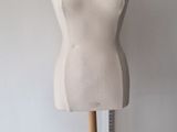 a mannequin on a wooden stand in a room