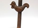 an image of a wooden sculpture of a bird on top of a wooden base