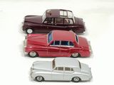 several toy cars are lined up in a row on a white surface