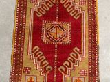 rug on the floor is red and beige with a geometric design