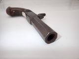 a gun that is laying on a white table