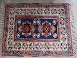 un vieux tapis orné d'un motif bleu et rouge