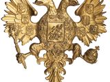 une image représentant un aigle doré surmonté d'une couronne