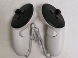 two video game controllers sitting next to each other on the floor