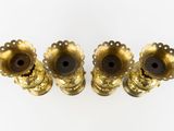 three brass candlesticks on a white surface with a white background