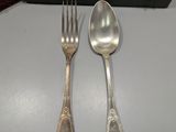 two forks and two spoons sitting on a table