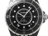 a black and white watch with diamonds on the face
